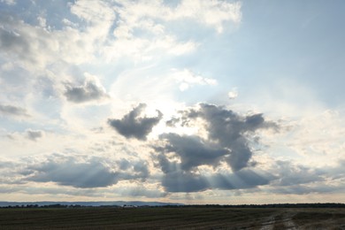 Photo of Sun shining through clouds on beautiful sky