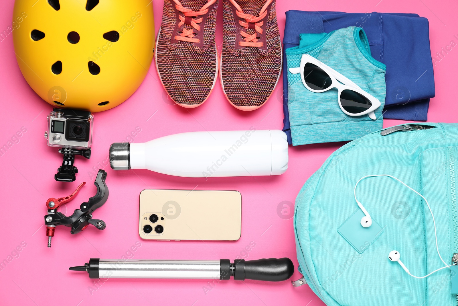 Photo of Flat lay composition with bicycle accessories on pink background