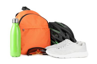 Photo of Bicycle helmet, goggles, thermo bottle, sneakers and backpack isolated on white