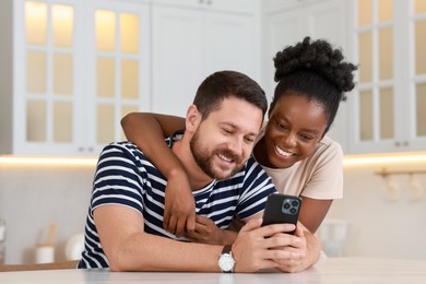 Photo of International relationships. Lovely couple spending time together in kitchen