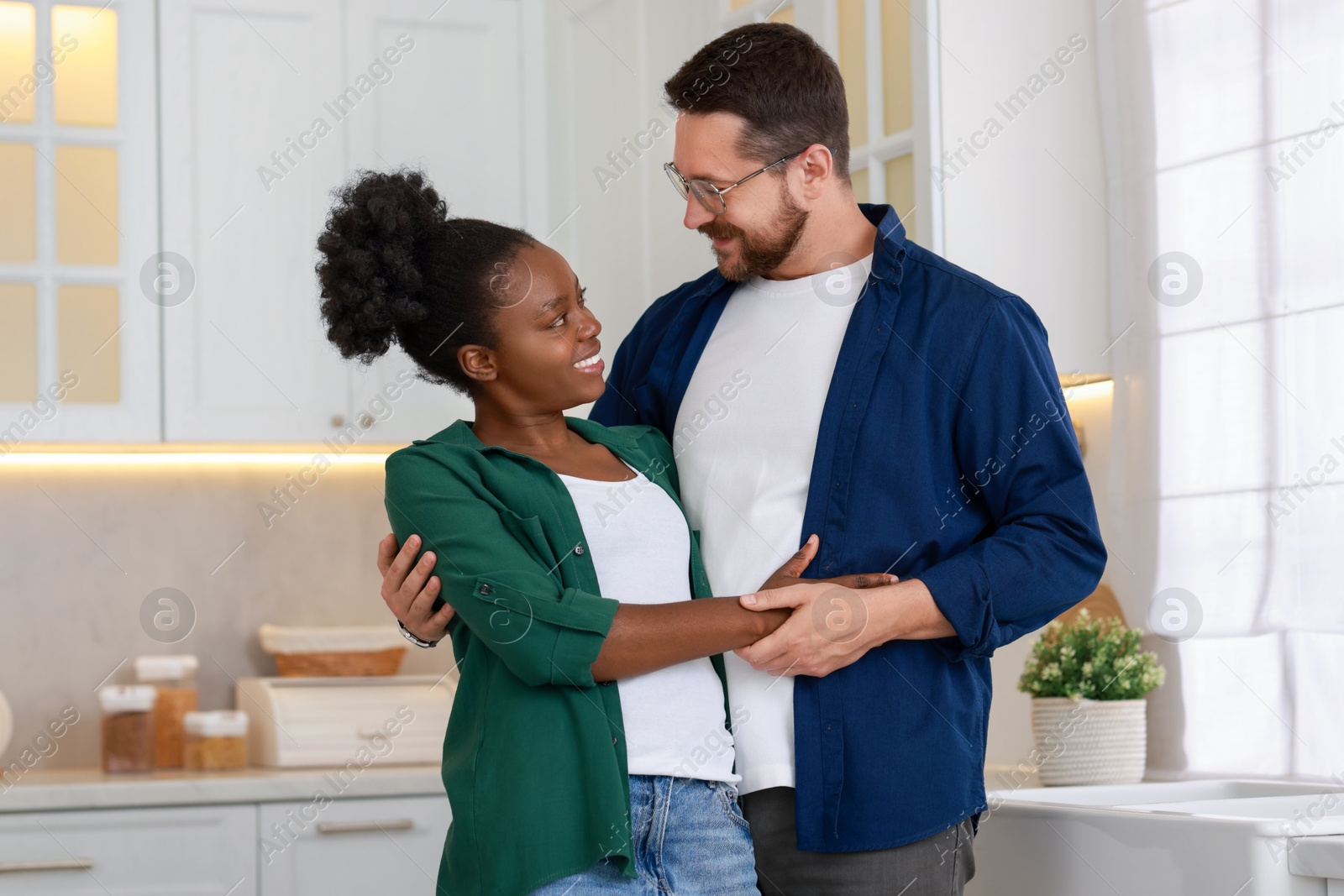 Photo of International relationships. Portrait of lovely couple in kitchen