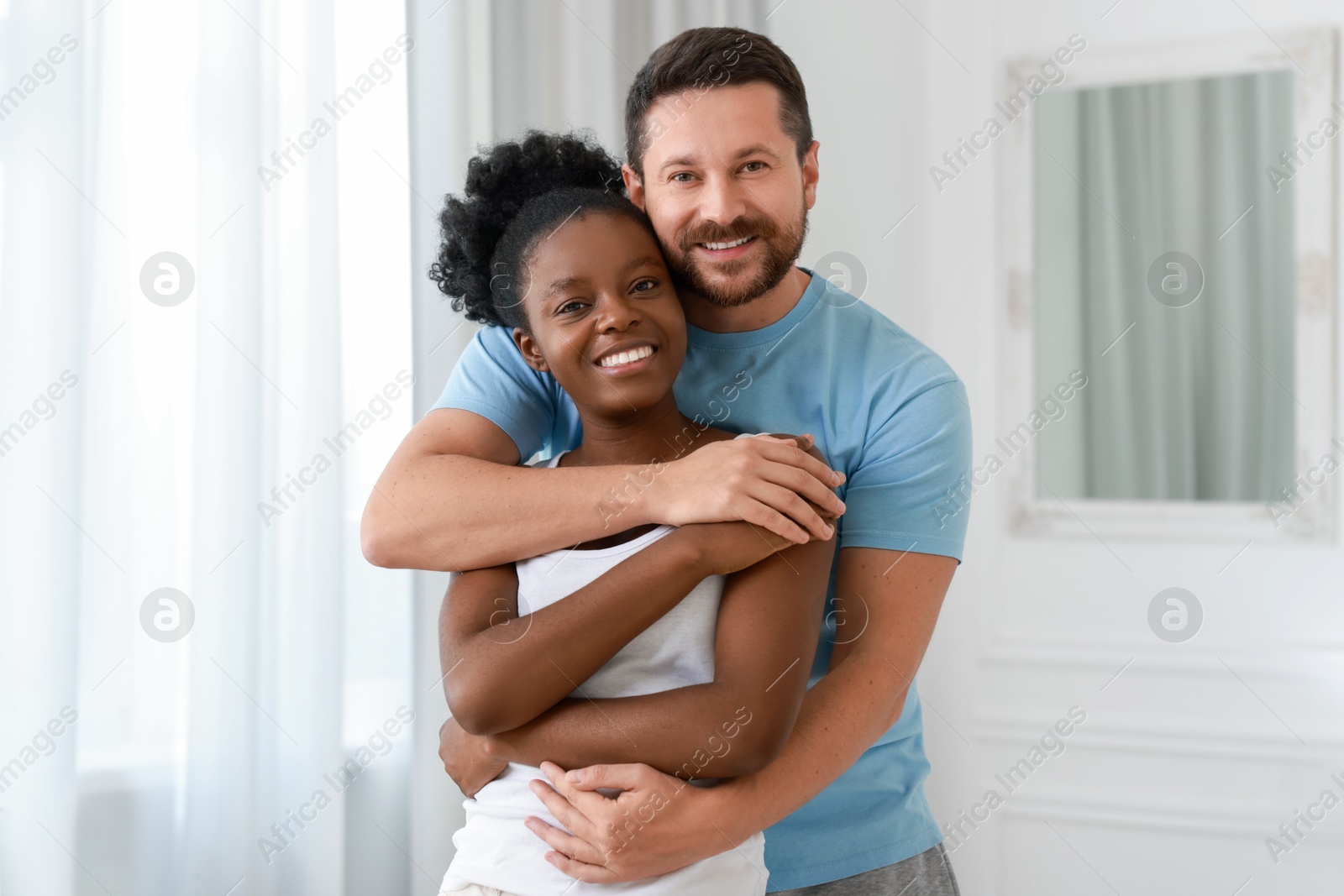 Photo of International relationships. Portrait of lovely couple at home