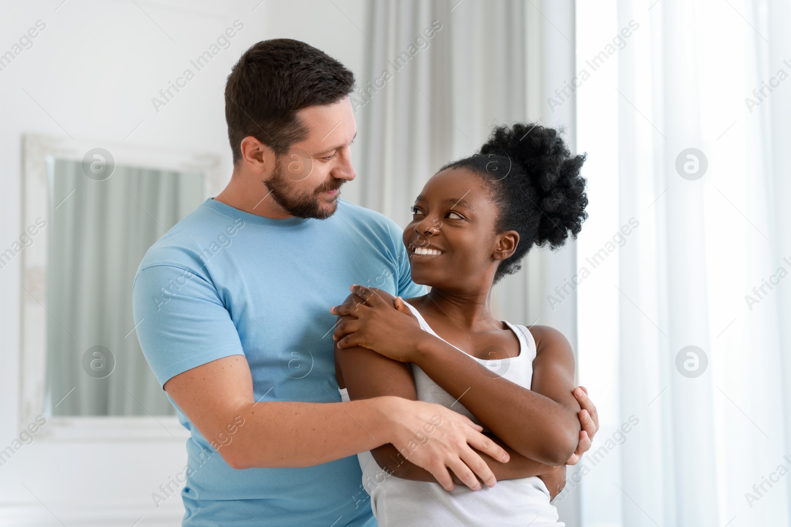 Photo of International relationships. Portrait of lovely couple at home