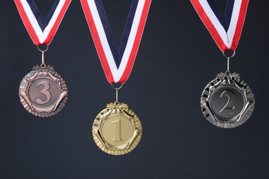 Photo of Golden, silver and bronze medals on dark grey background