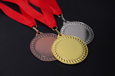 Photo of Golden, silver and bronze medals on black background, closeup