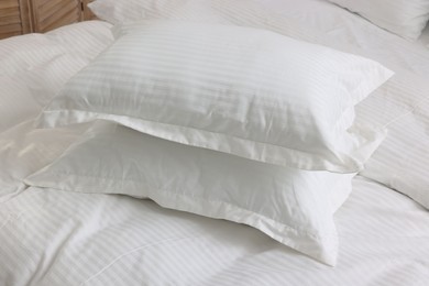 Photo of Bed with clean linens and pillows at home