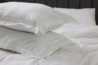 Bed with clean linens and pillows at home