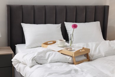 Breakfast tray on bed with beautiful linens indoors