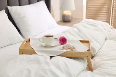 Breakfast tray on bed with beautiful linens indoors