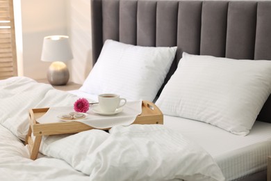 Breakfast tray on bed with beautiful linens indoors