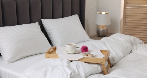 Breakfast tray on bed with beautiful linens indoors