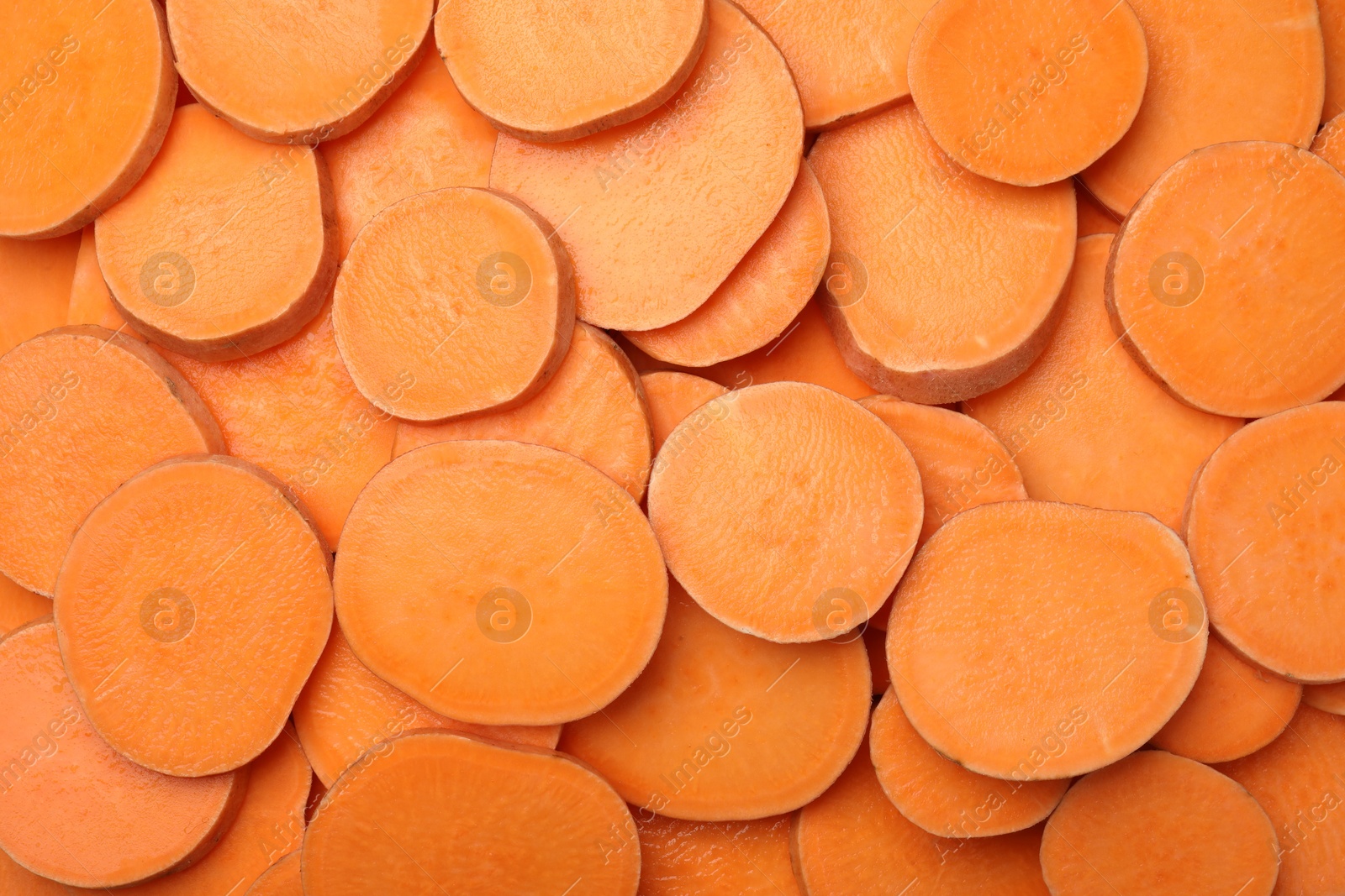 Photo of Slices of raw sweet potatoes as background, top view