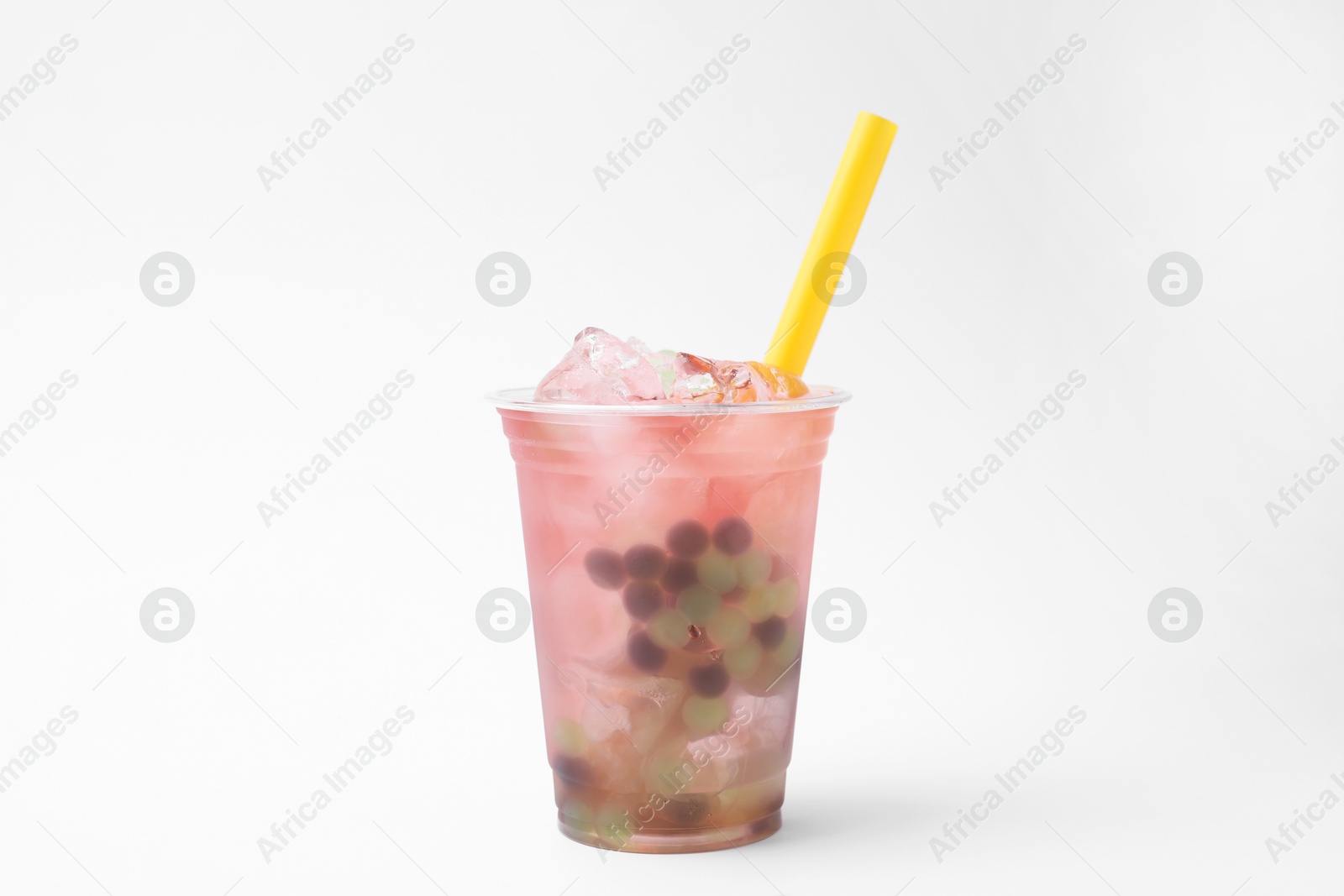 Photo of Tasty bubble tea in plastic cup on white background