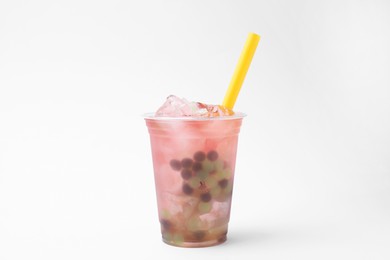 Photo of Tasty bubble tea in plastic cup on white background