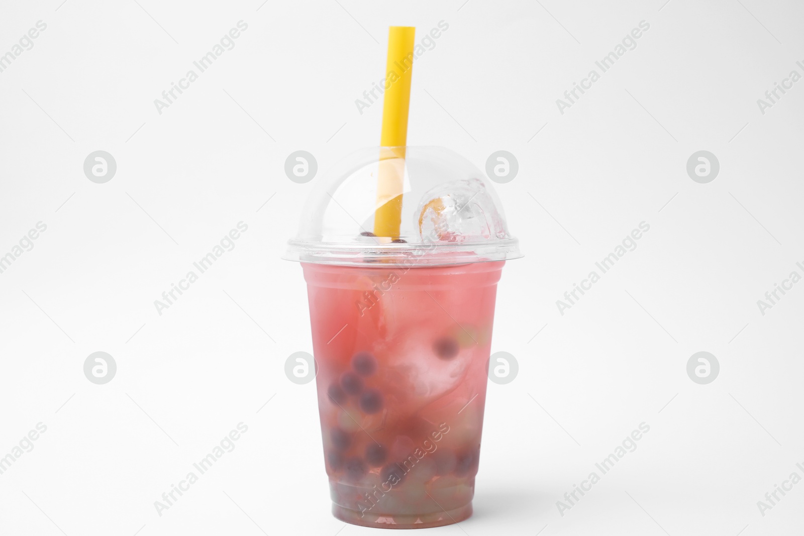 Photo of Tasty bubble tea in plastic cup on white background