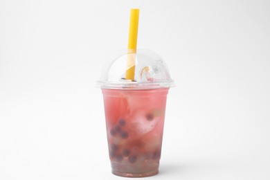 Photo of Tasty bubble tea in plastic cup on white background