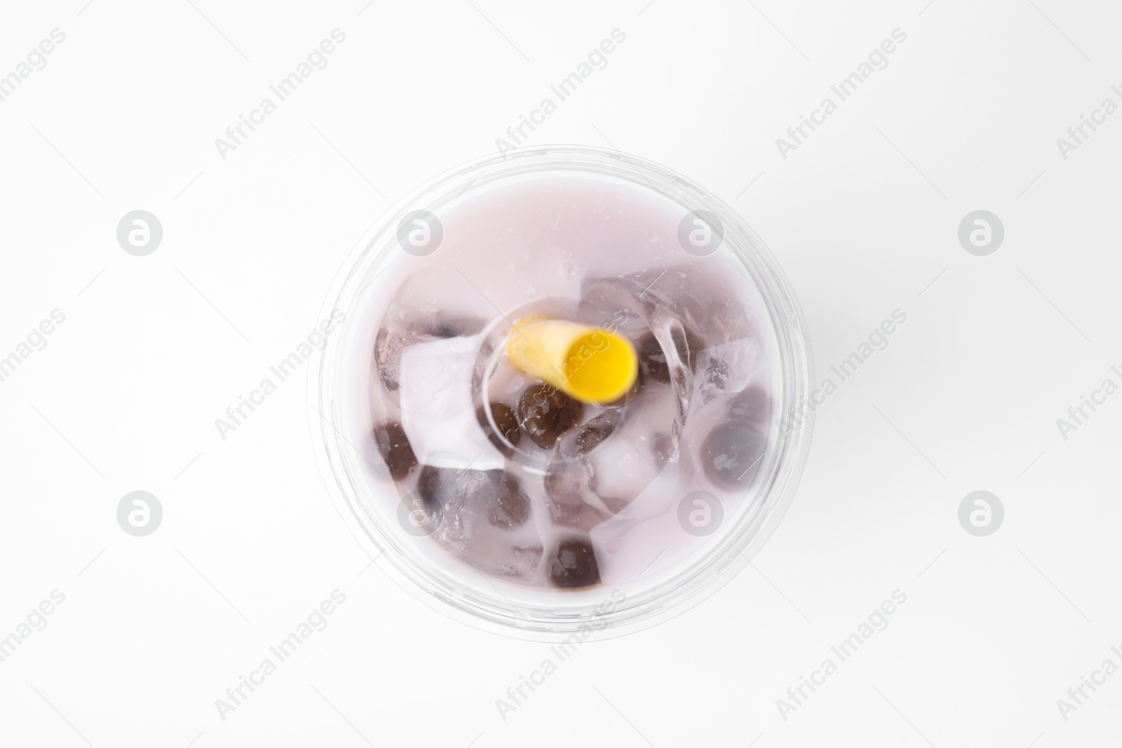 Photo of Tasty milk bubble tea in plastic cup on white background, top view