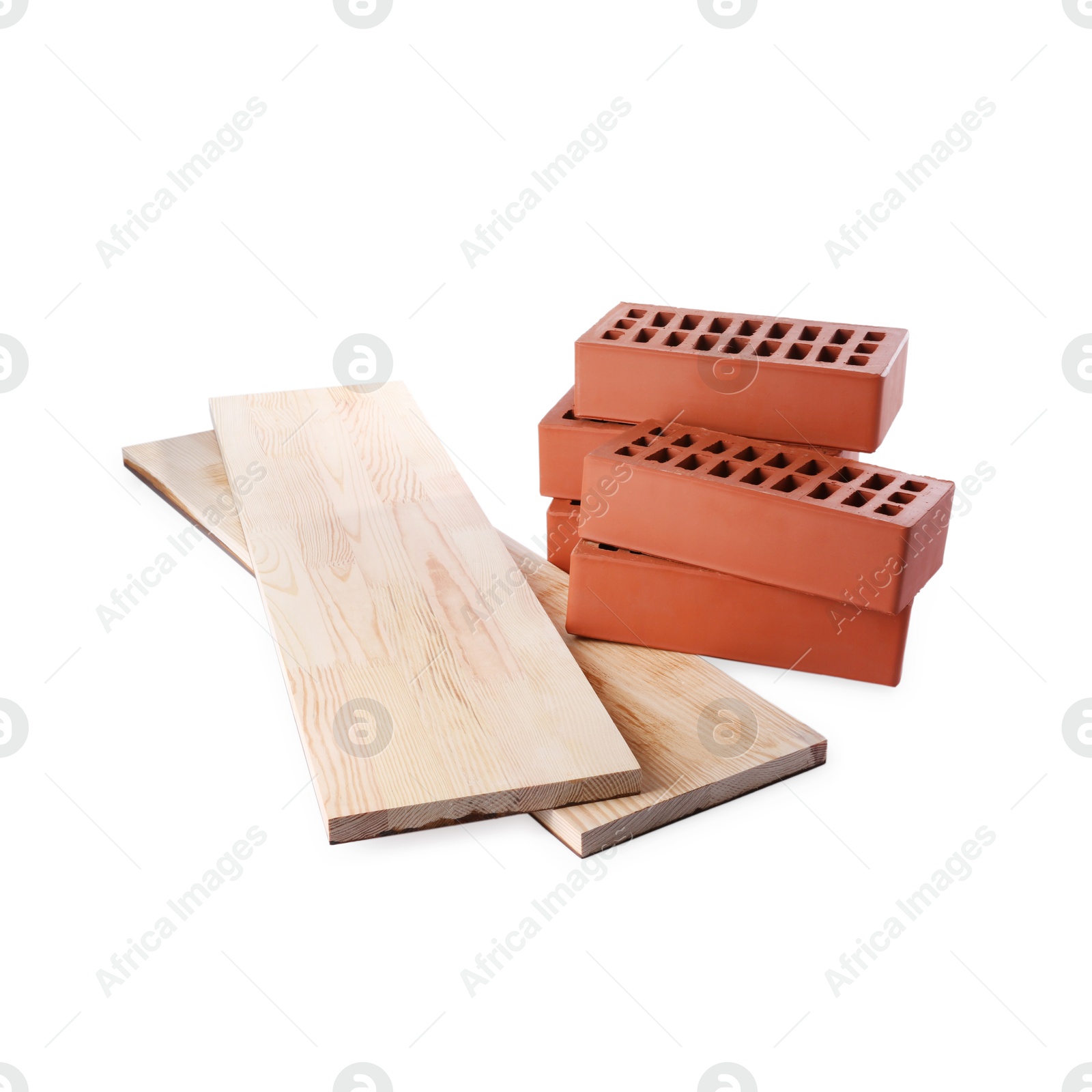 Photo of Wooden planks and red bricks isolated on white. Building materials