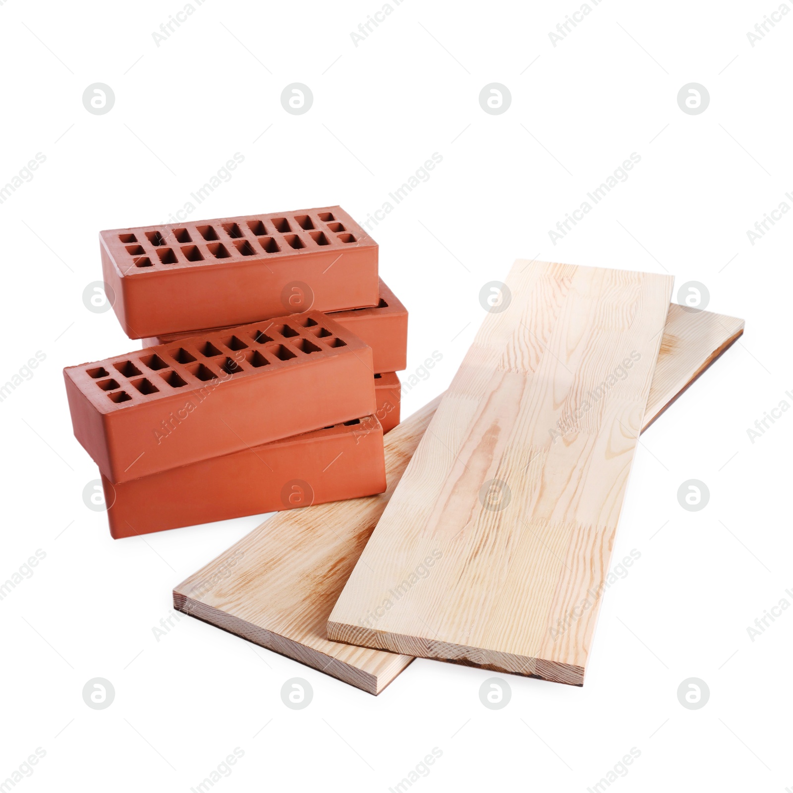 Photo of Wooden planks and red bricks isolated on white. Building materials