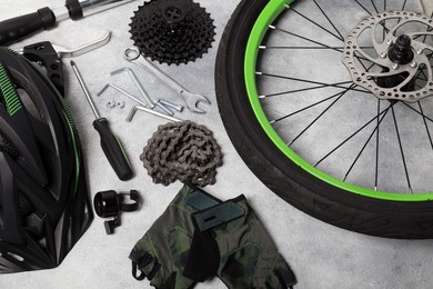 Photo of Parts of bicycle and tools on grey background