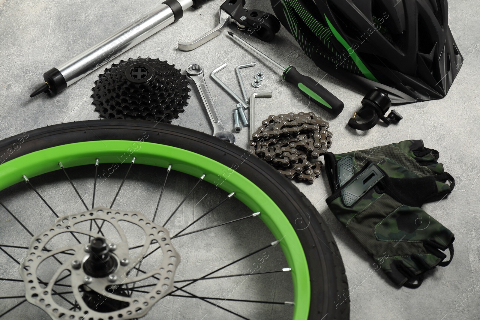 Photo of Parts of bicycle and tools on grey background