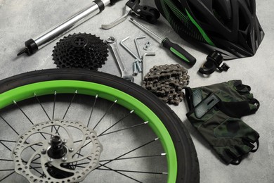 Parts of bicycle and tools on grey background