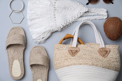 Photo of Stylish straw bag and summer accessories on grey background, flat lay