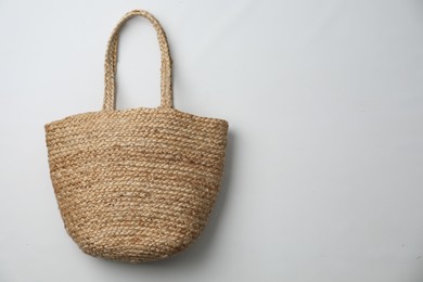 Photo of Stylish straw bag on white background, top view. Summer accessory