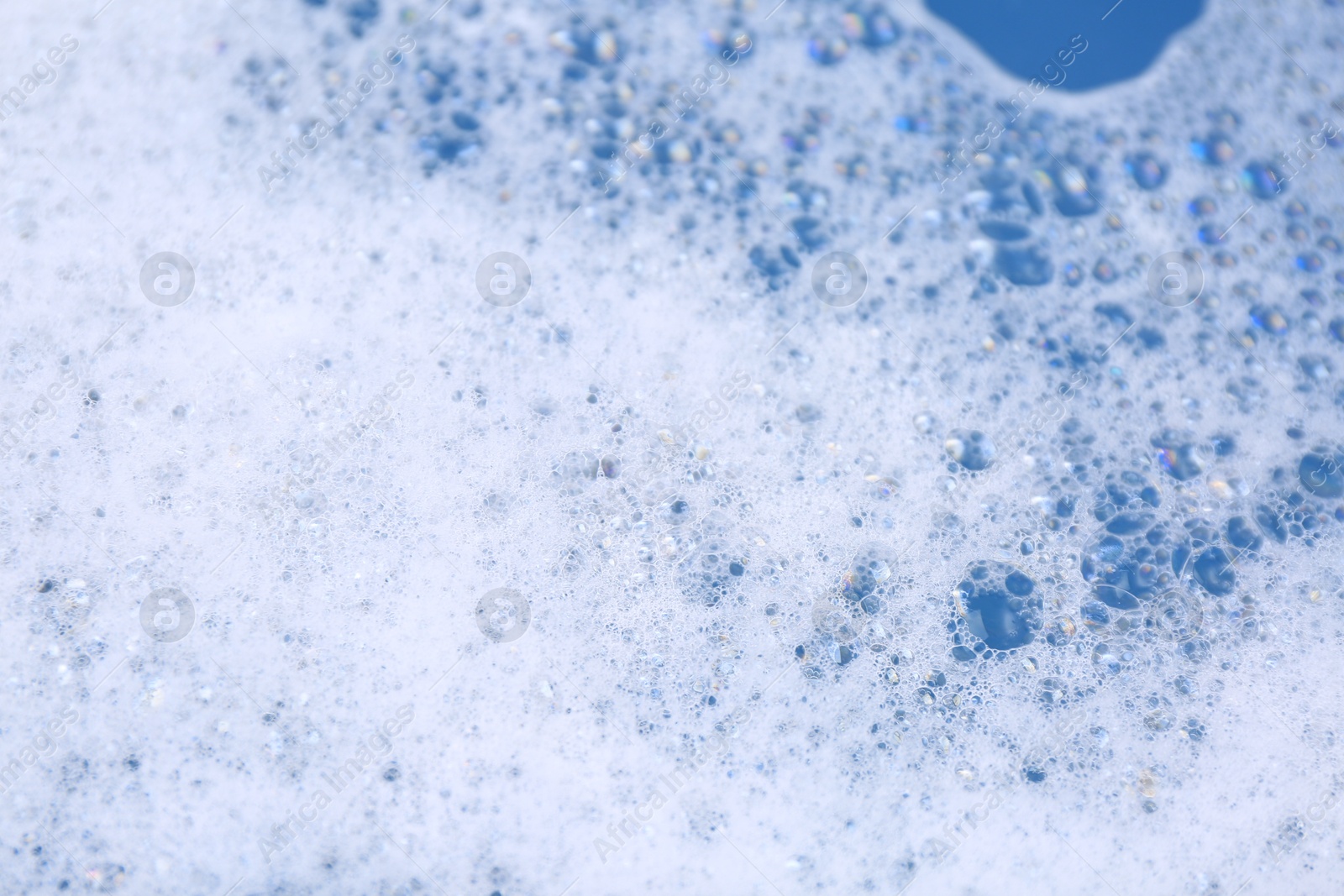 Photo of Detergent foam as background, closeup. Hand washing laundry