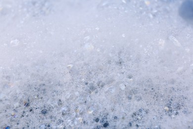 Photo of Detergent foam as background, closeup. Hand washing laundry