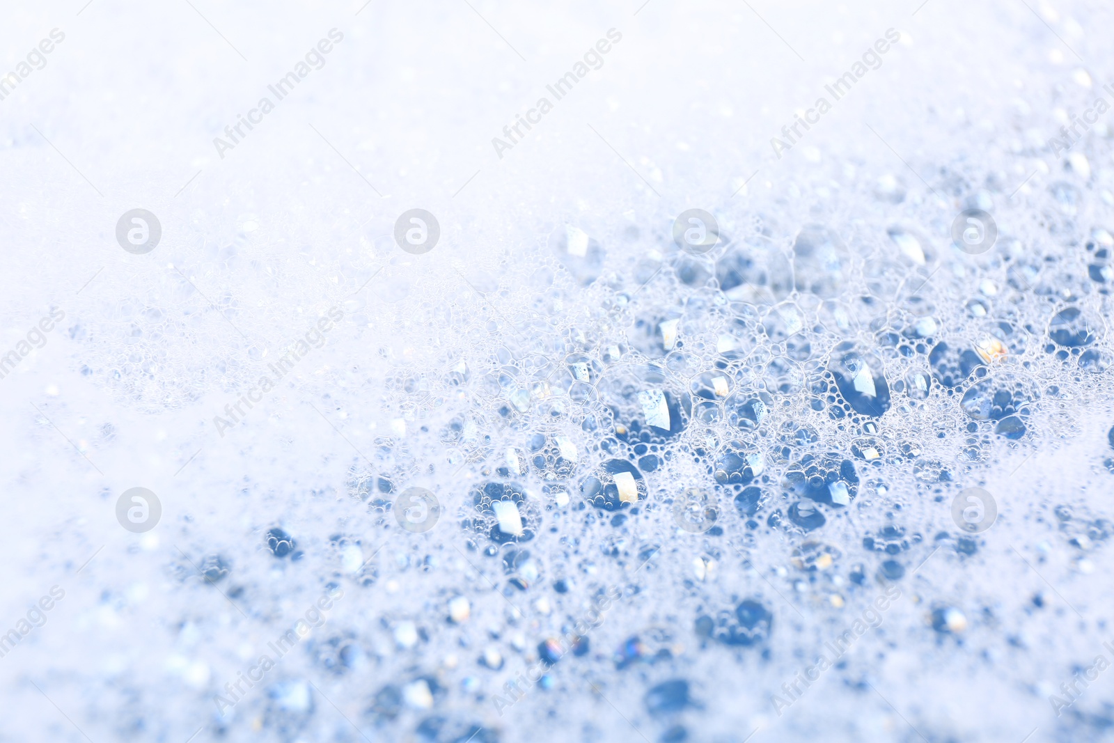 Photo of Detergent foam as background, closeup. Hand washing laundry