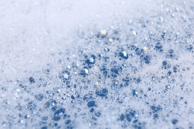 Photo of Detergent foam as background, closeup. Hand washing laundry