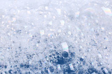 Photo of Detergent foam as background, closeup. Hand washing laundry