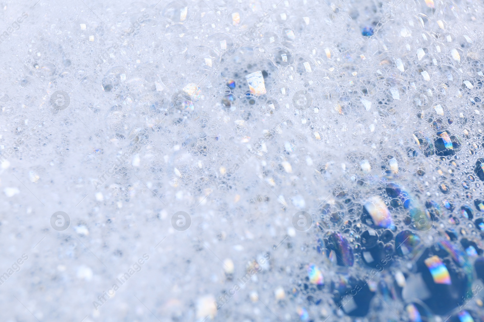 Photo of Detergent foam as background, closeup. Hand washing laundry