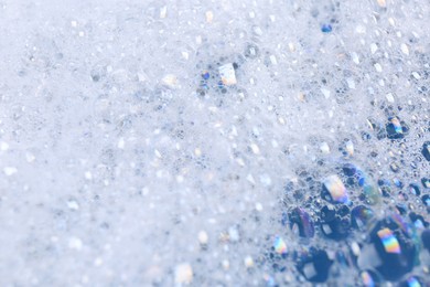 Photo of Detergent foam as background, closeup. Hand washing laundry