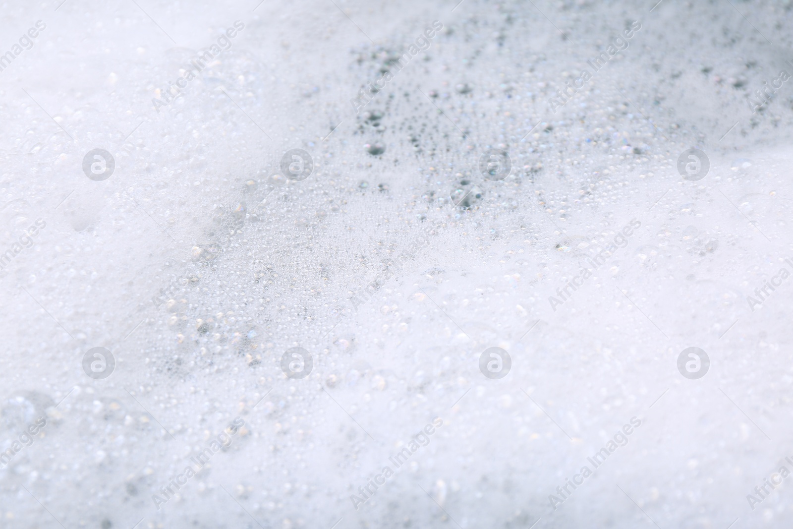 Photo of Detergent foam as background, closeup. Hand washing laundry