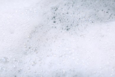 Photo of Detergent foam as background, closeup. Hand washing laundry