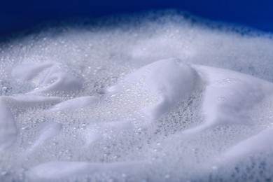 Photo of White garment in suds, closeup. Hand washing laundry