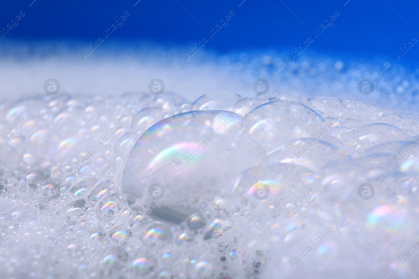 Photo of White detergent foam, closeup. Hand washing laundry