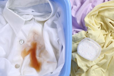 Photo of Garment and powdered detergent near basin with white shirt, top view. Hand washing laundry