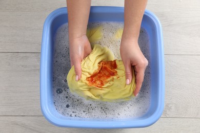 Photo of Woman washing garment with stain, top view