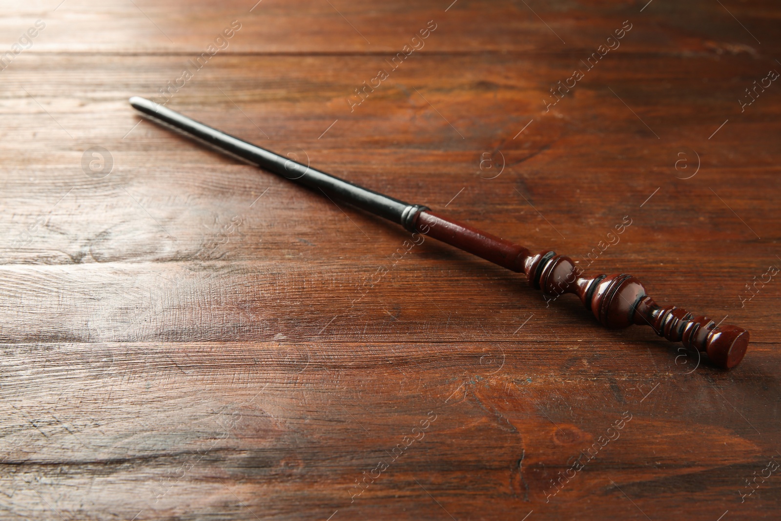 Photo of One old magic wand on wooden table