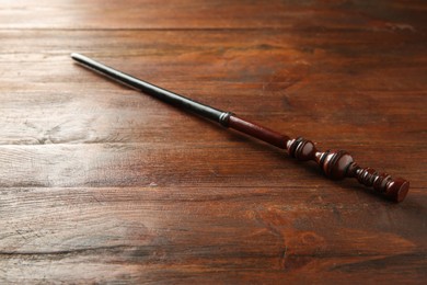 Photo of One old magic wand on wooden table