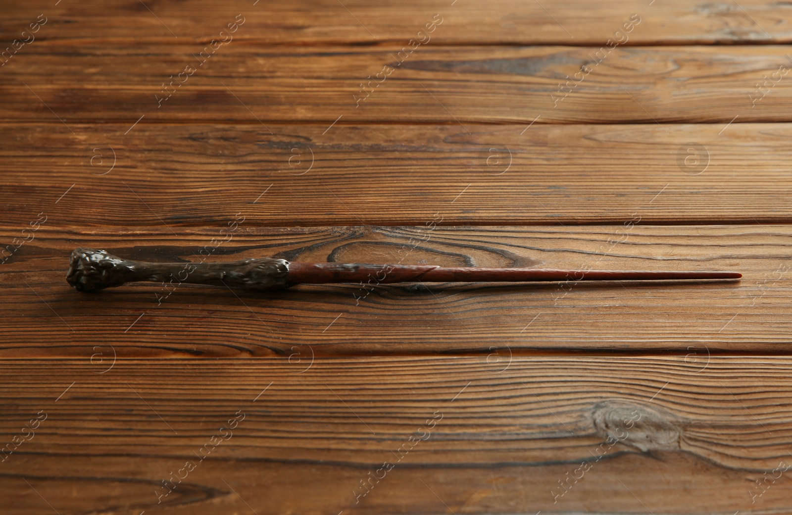 Photo of One old magic wand on wooden table