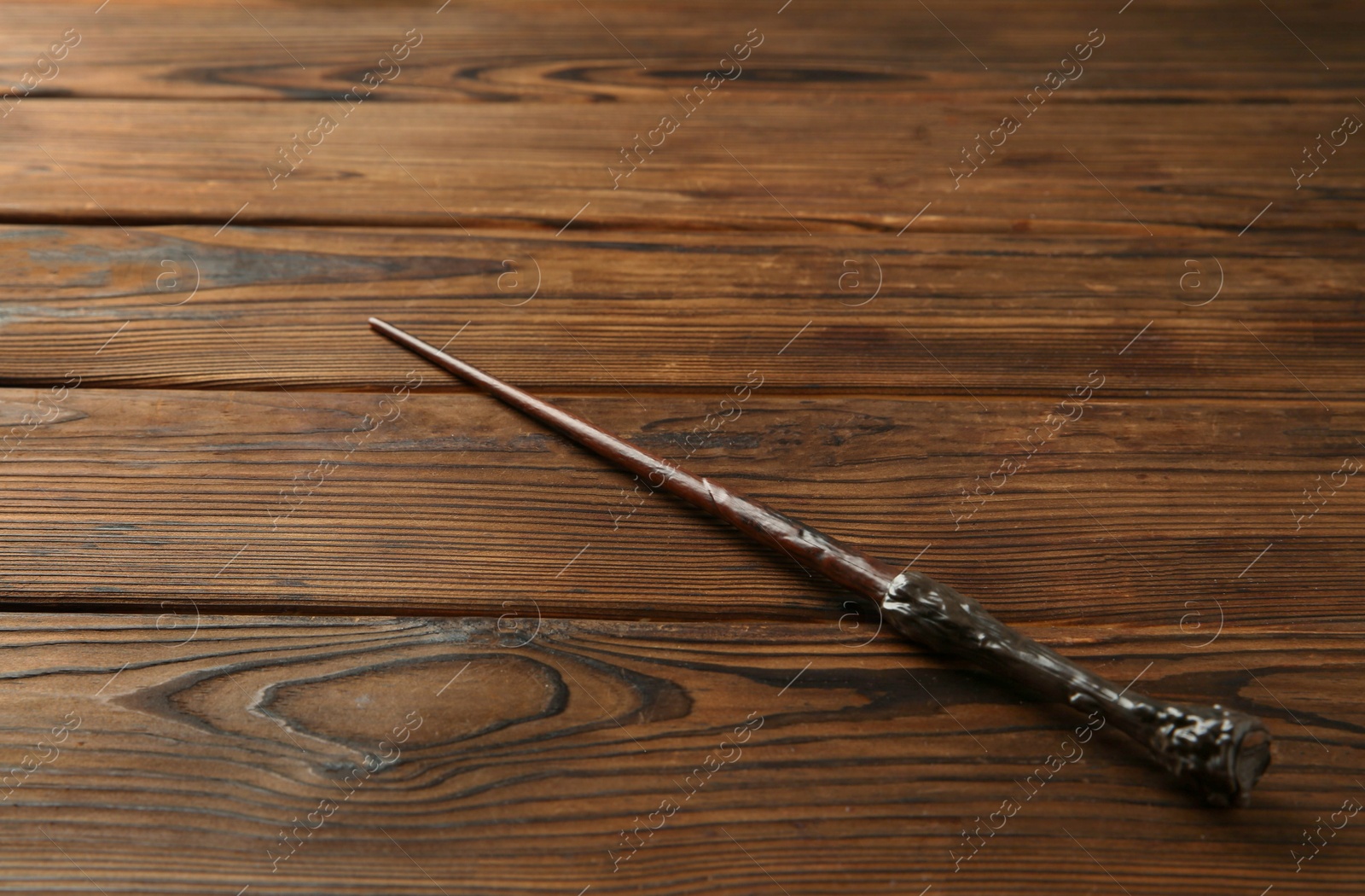 Photo of One old magic wand on wooden table