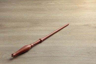 Photo of One magic wand on light wooden table