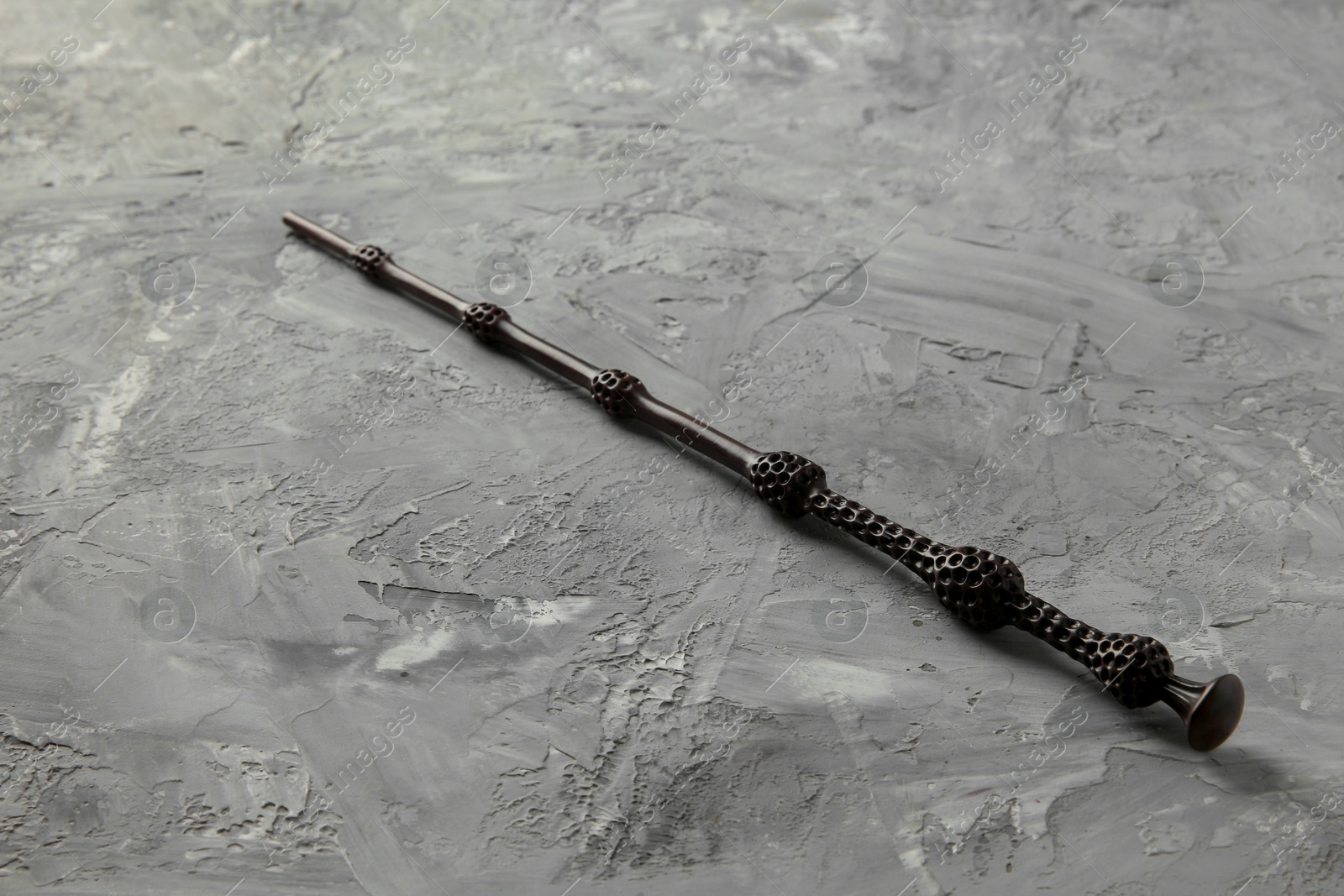 Photo of One magic wand on grey textured table