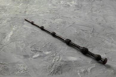 Photo of One magic wand on grey textured table