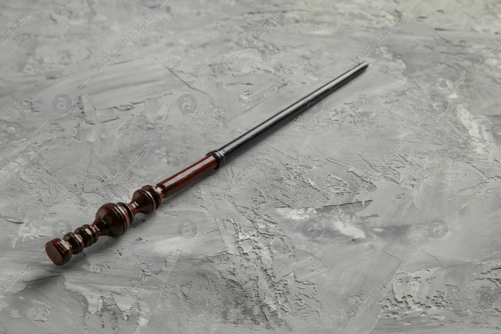 Photo of One magic wand on grey textured table