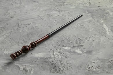 Photo of One magic wand on grey textured table